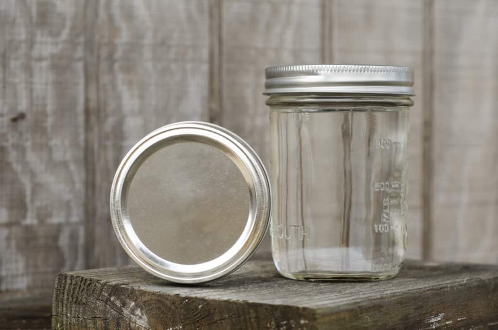 Empty mason jar on block of wood
