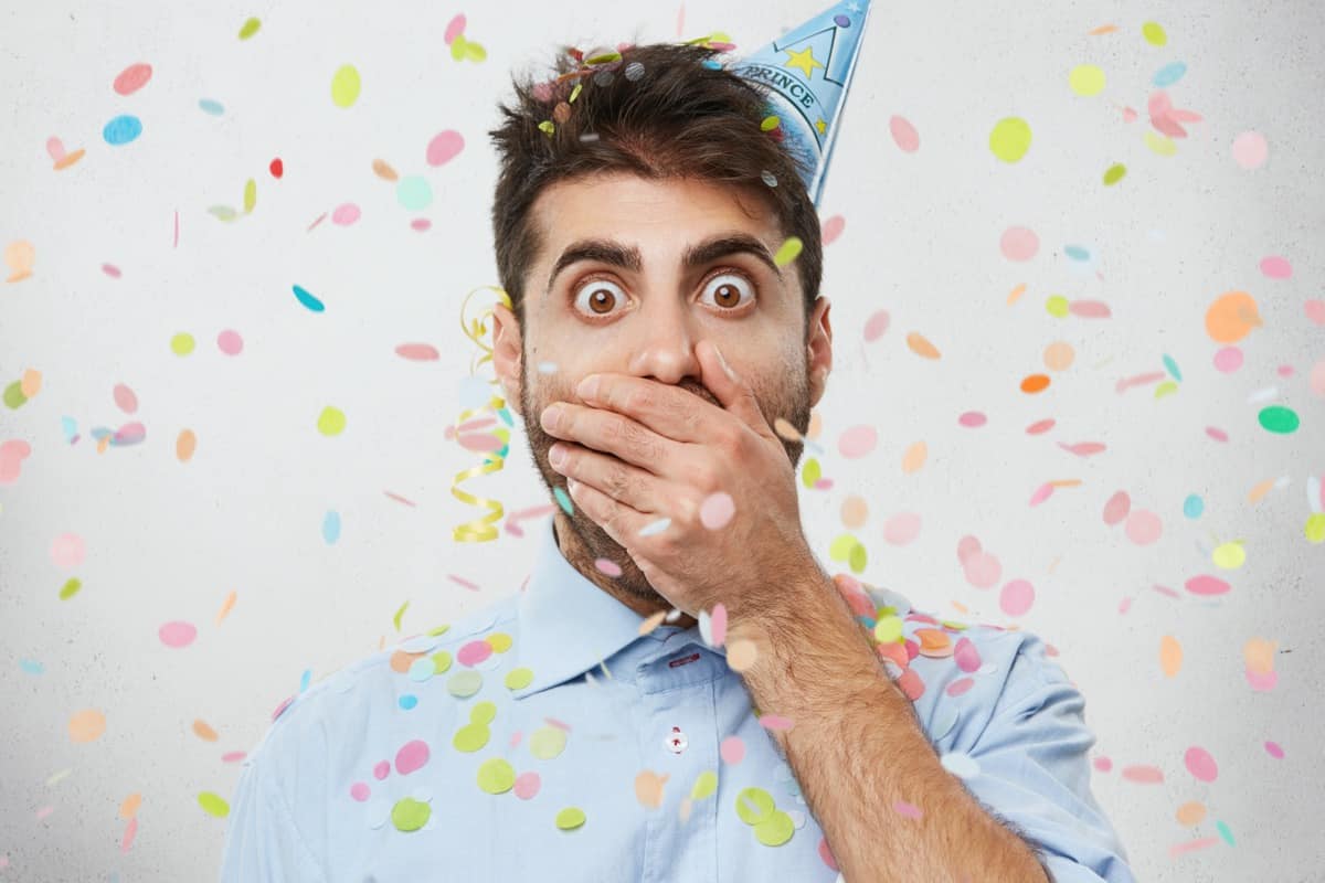 Surprised man in party hat