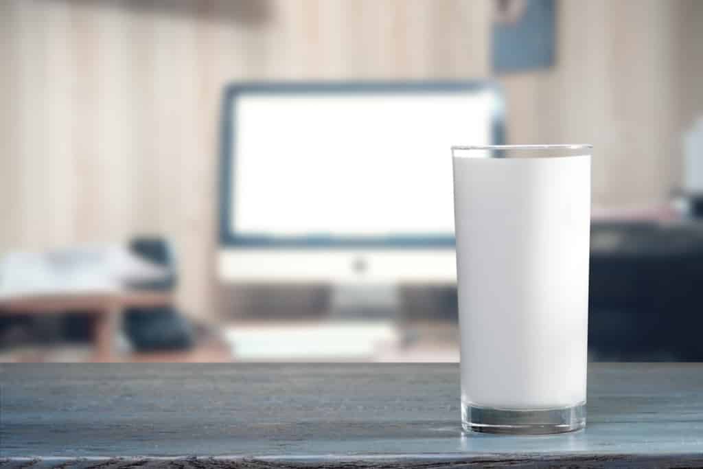 Glass of milk on table